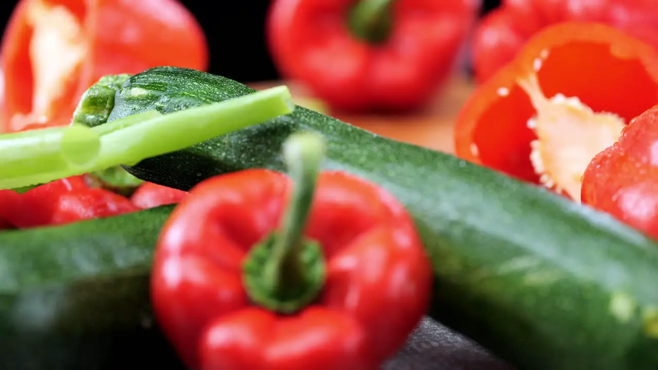 Fresh vegetables with peppers leeks carrots and leeks lying on wooden chopping board close-up