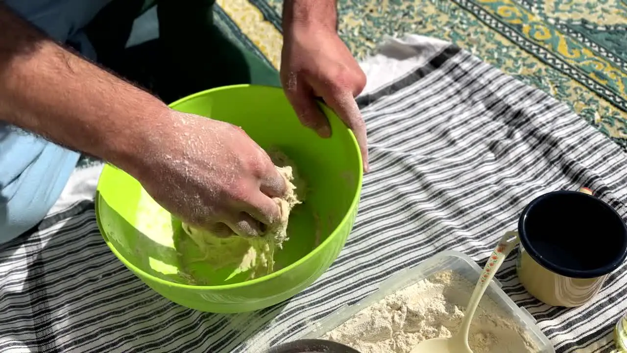 traditional bakery skill handmade flour sour dough bread in a bowl in rural area for cookies and flat bread in clay oven baker chef kneading the mixture prepare for fermentation in the town in Gilan