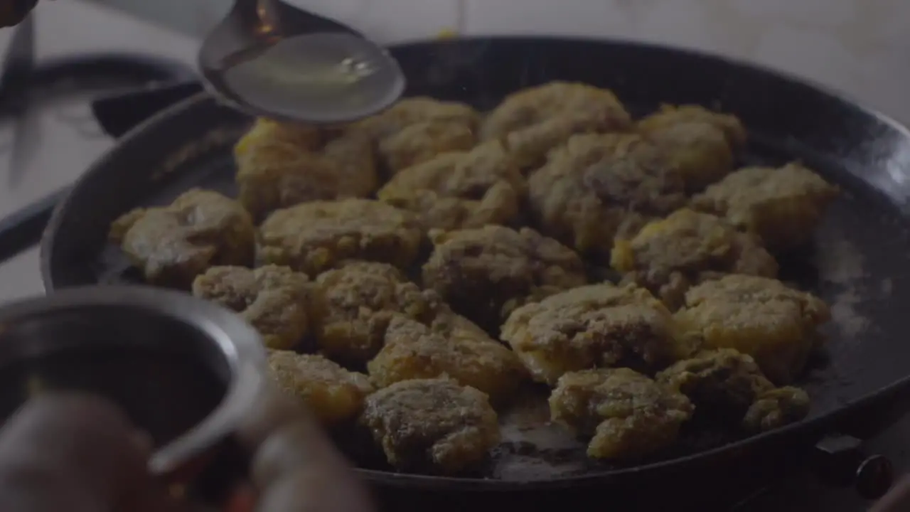 pouring oil on fried rava prawns in hot pan