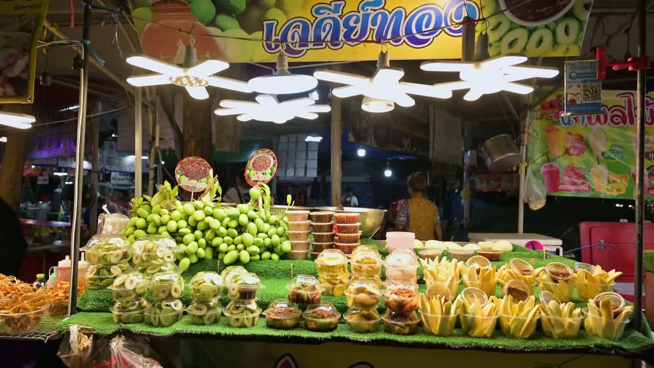 Spicy and savory mangoes displayed and sold by hawkers in the walking street of Chatuchak Weekend Night Market in Bangkok Thailand