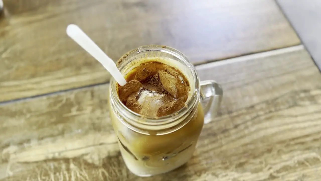 dirty iced chai latte in a mason jar on table top cinnamon cacao chai latte tea delicious treat yourself food concept cheatday sweet tooth straw chai latte chai drink