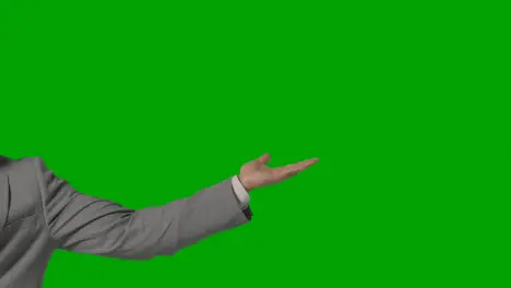 Close Up Of Arm Of Businessman In Suit Presenting Or Showing Something Against Green Screen 