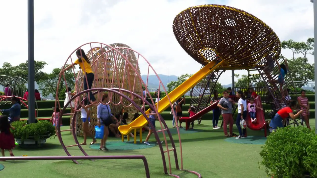 Supervised by parents and guardians frolicking young kids explore the playground attractions at SM Seaside Mall on South Road Properties Cebu City Philippines