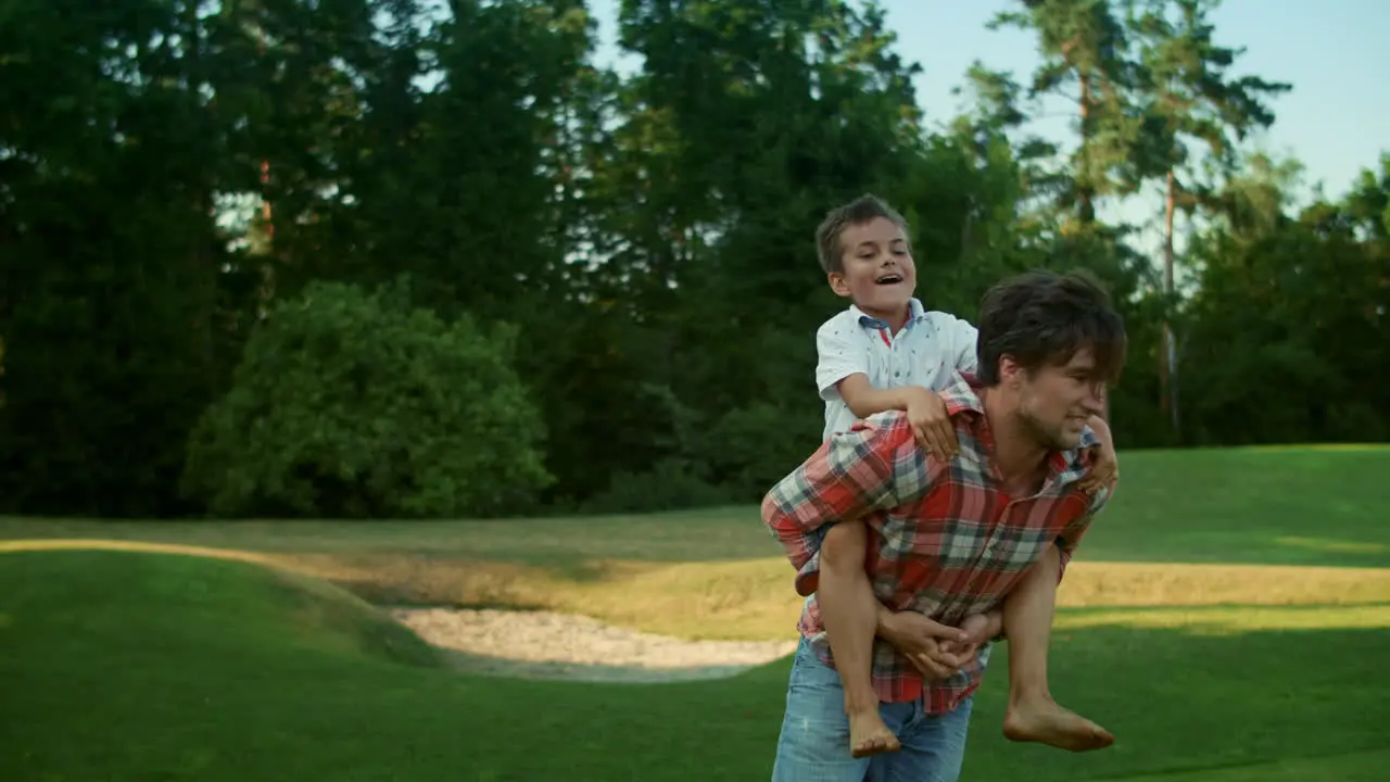 Father and son playing together in park