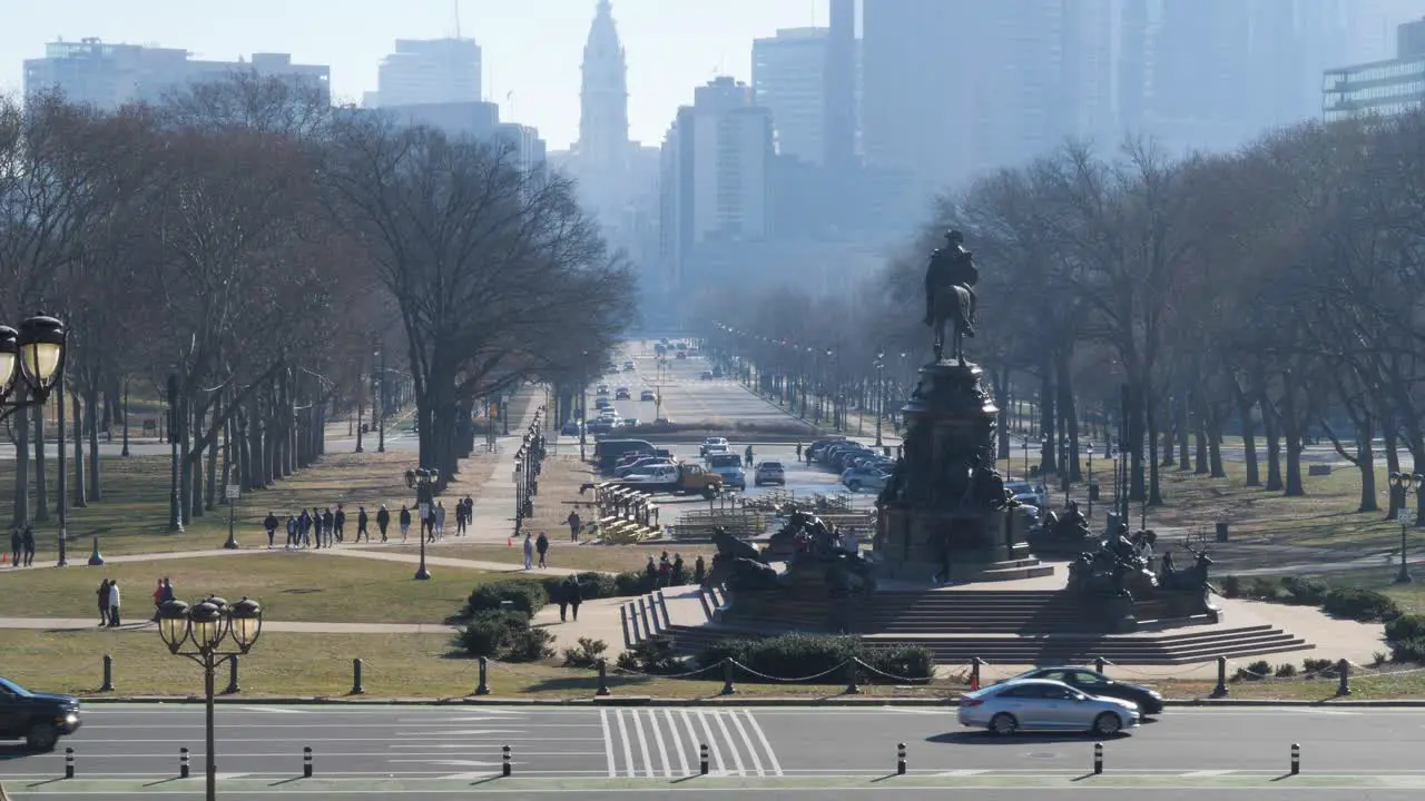 Cars pass by a statue in philadelphia in slow motion