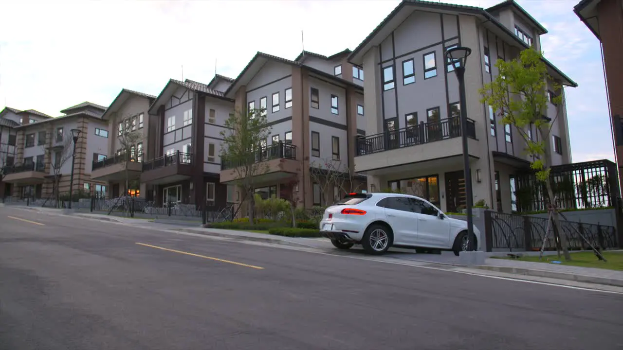 Porsche passenger vehicle returning to house late in afternoon