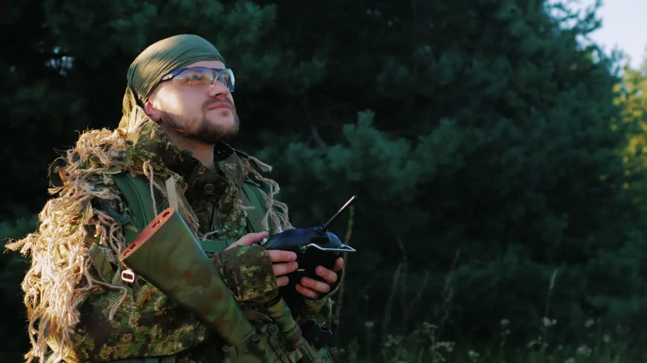 Armed Men In Camouflage Uses A Remote Control Looking Up