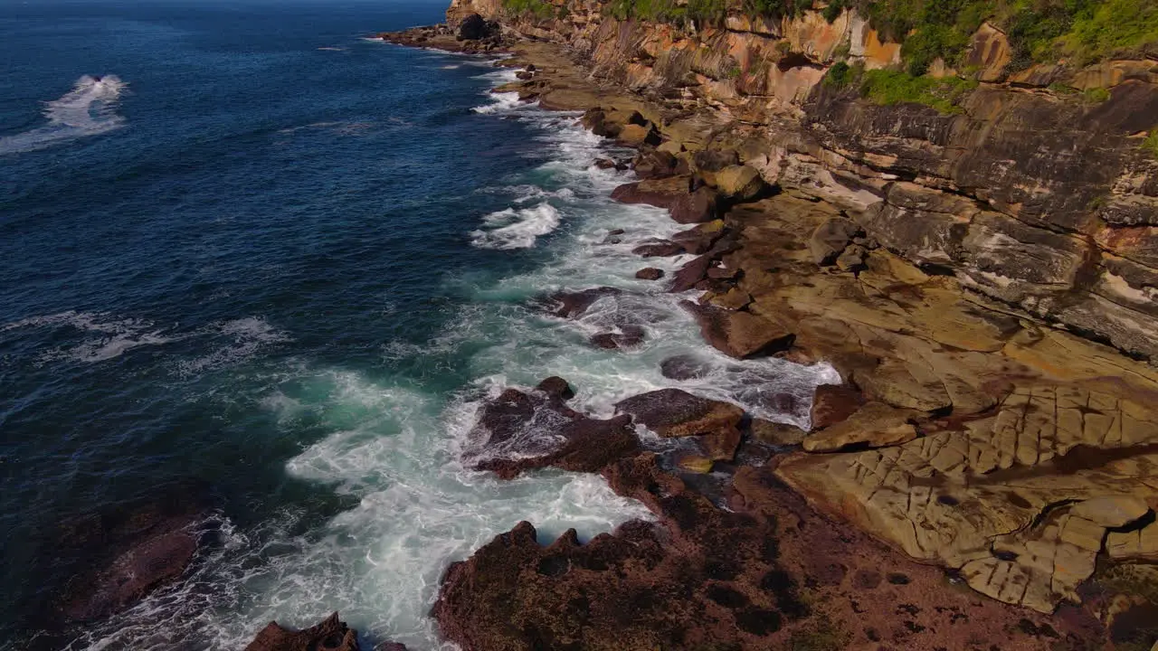 High moving drone shot was waves smashing rock wall