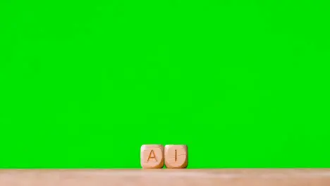 Business Concept Wooden Letter Cubes Or Dice Spelling AI Against Green Screen