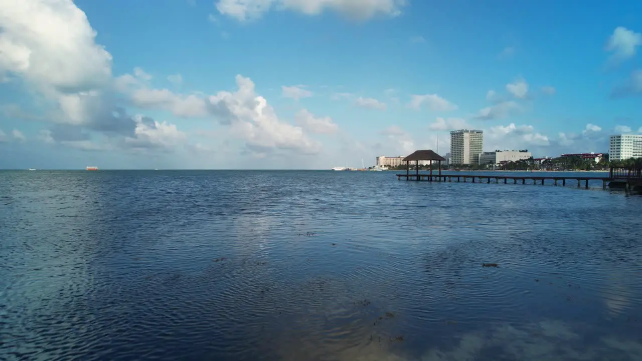 Aerial Drone Flyover Scenic Blue Ocean With Woman Walking Along Rocky Shore Cancun Mexico 4K