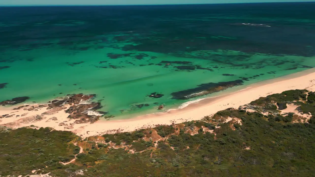 drone shot over redgate beach with waves crushing on the shore near Margaret River in Western Australia