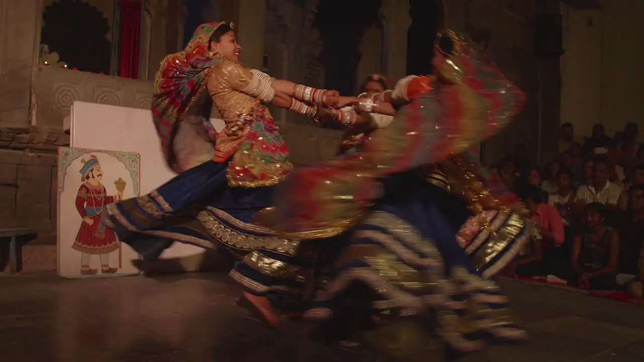 Young women enjoying dancing together in traditional clothing slow-mo