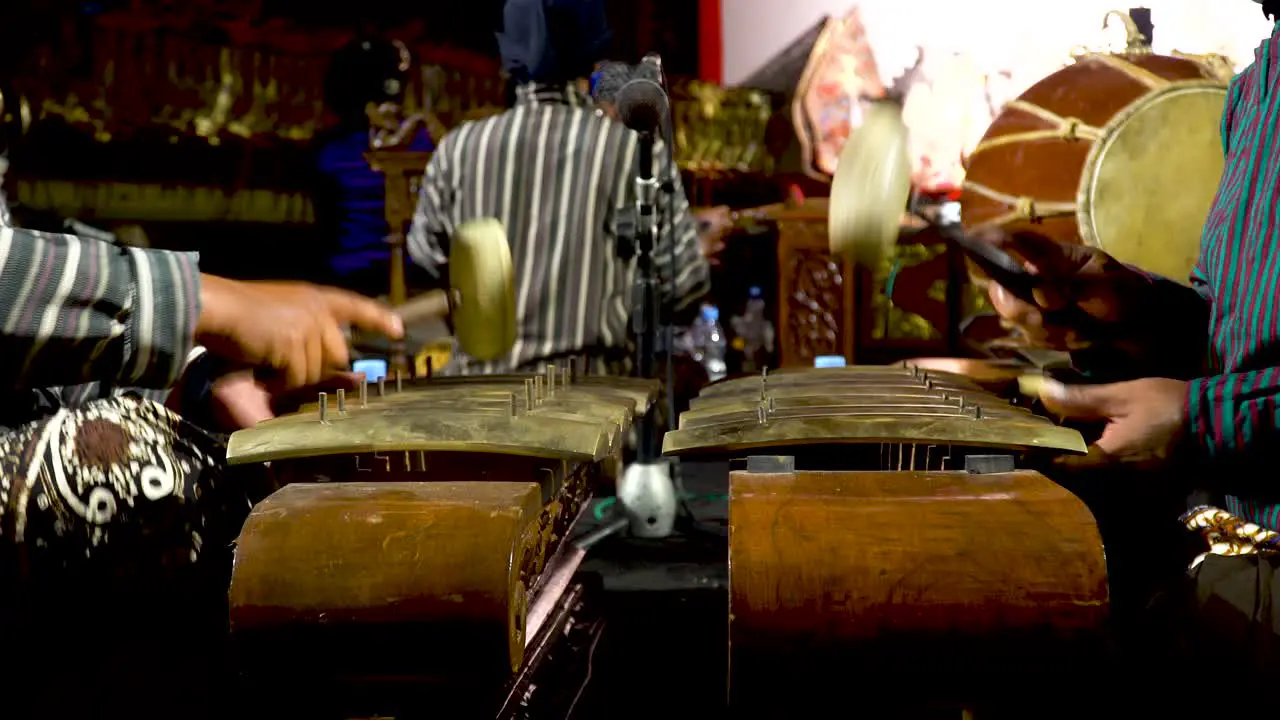 Close up on musicians playing Gamelan traditional Javanese ensemble music