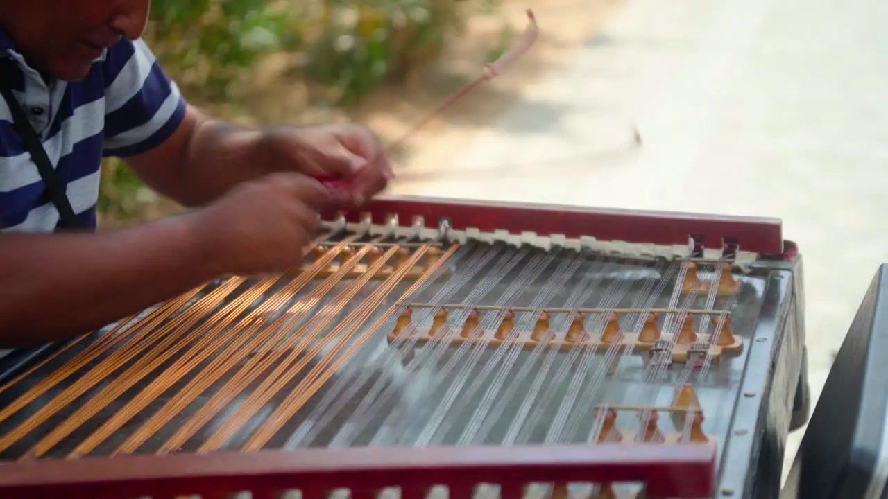 Street busker close up playing string instrument in Athens Greece