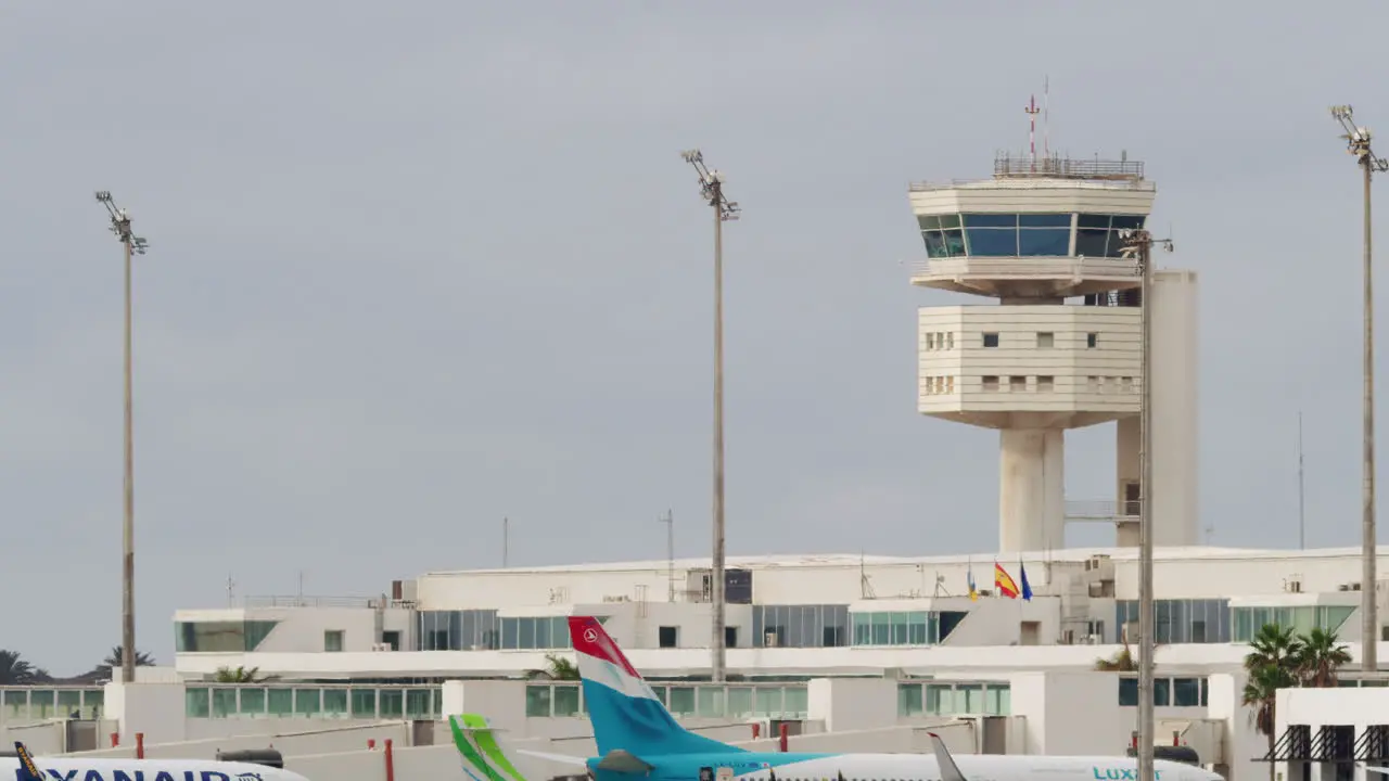 Terminal with aircraft taxiing and landing at sunset