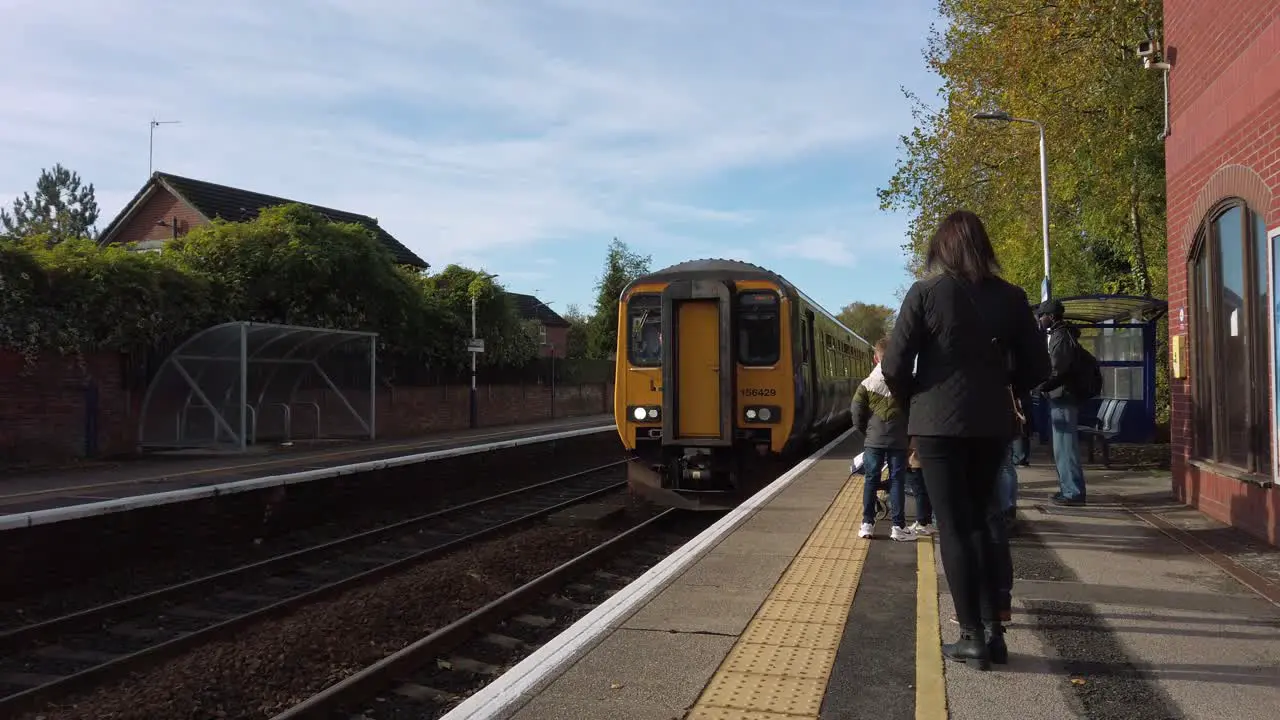 Northern rail train pulling up at Urmston station on Liverpool to Manchester line UK