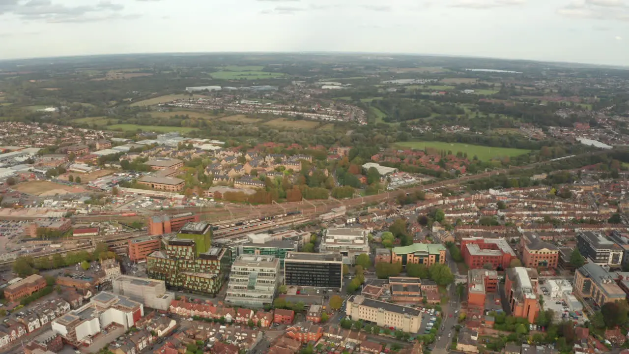 Aerial slider shot of high speed train passing through Watford station