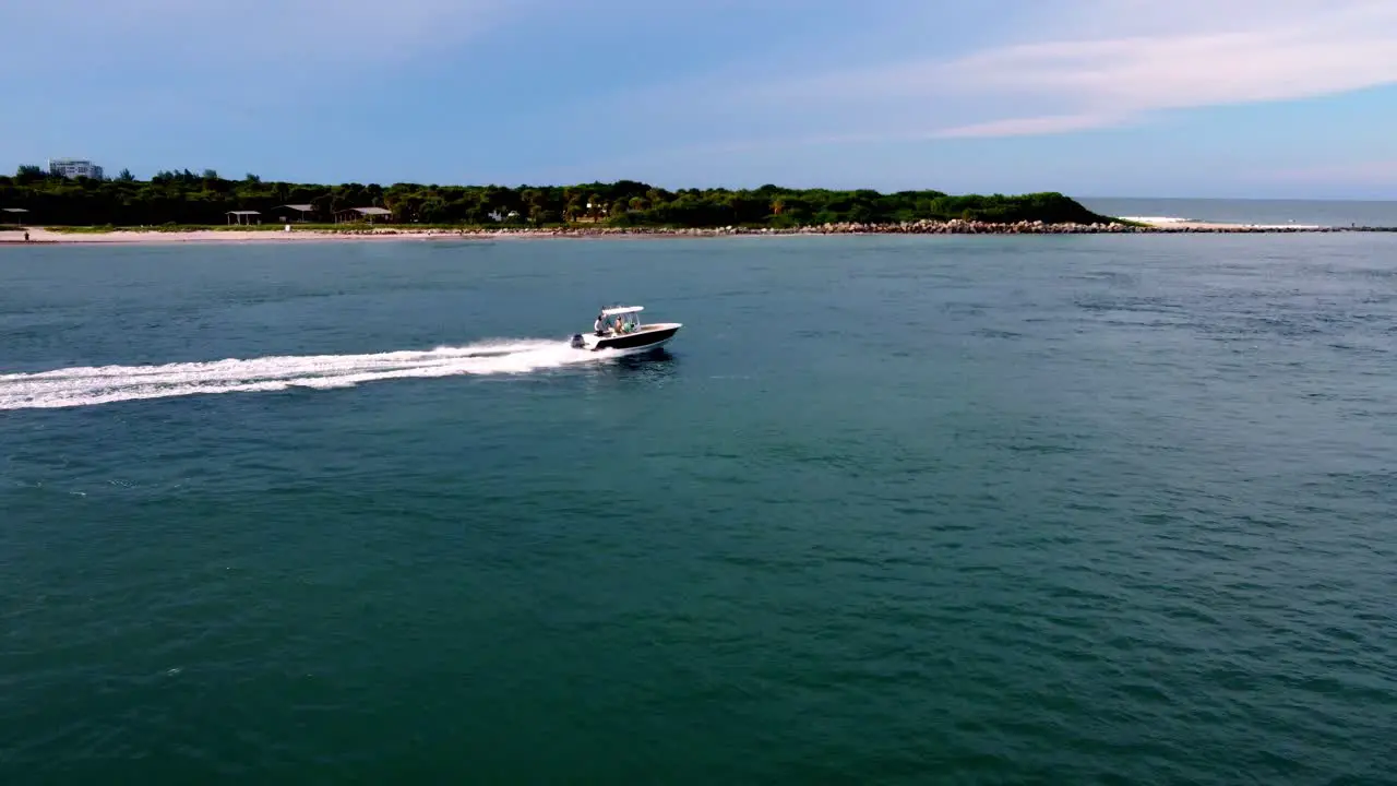 Drone chasing boat out into ocean waters Florida based fort pierce