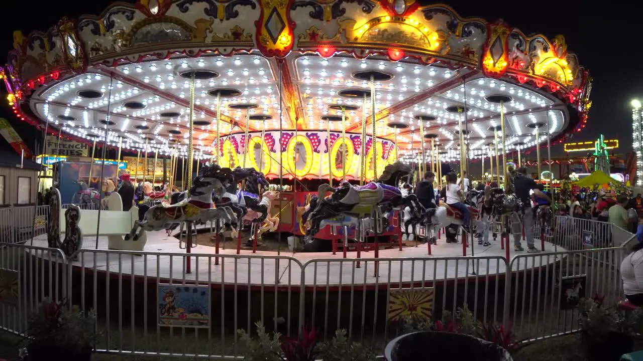 Tracking Shot of Carousel at Florida State Fair at Night in Slow Motion