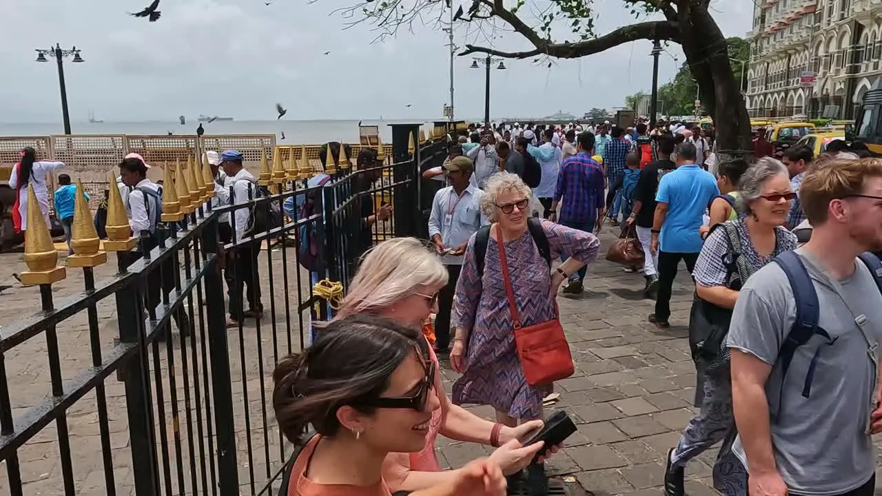 Mumbai India 20 August 2023 Tourists milling about taking selfies and generally enjoying themselves outside the Gateway of India