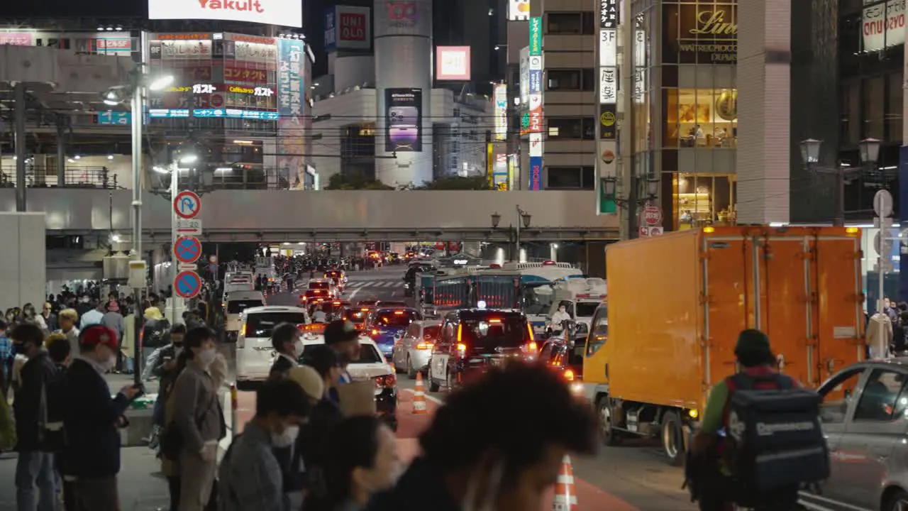 Streets of Shinjuku Busy Traffic while People Wait to Cross Road