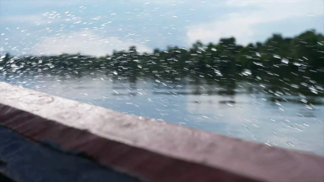 Medium shot of spray flicking up from Amazonian river boat travelling at speed on a sunny day