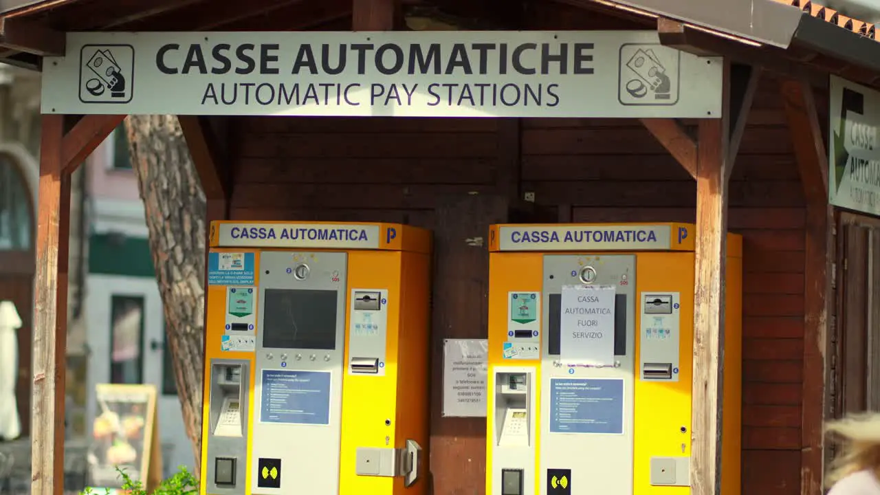 Woman taking a ticket from an automatic paying station for parking