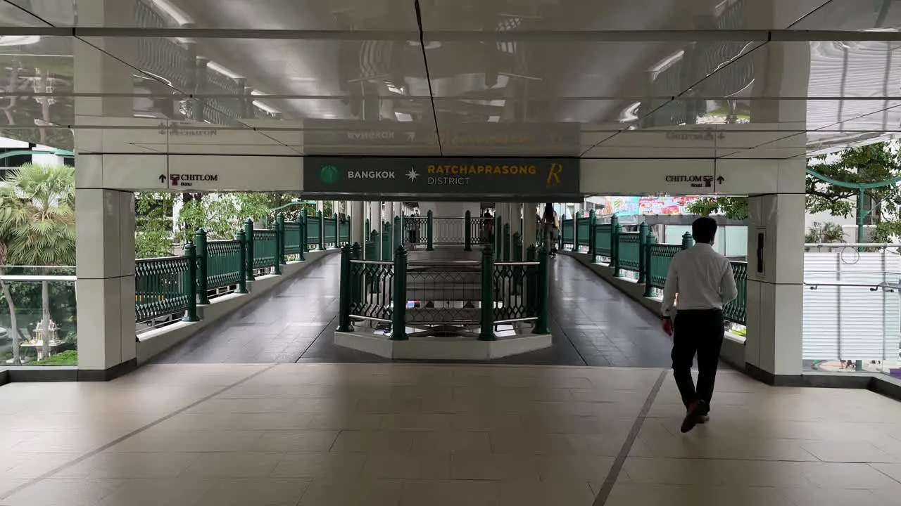 People walking Ratchaprasong skywalk towards ChitLom BTS Station