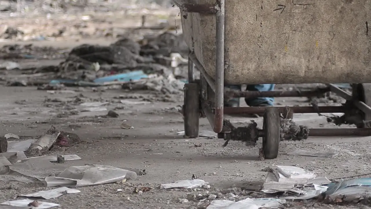 Pushing a cart through rubble in abandoned derelict mill