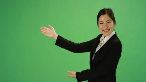 Businesswoman gesturing with arms on green screen