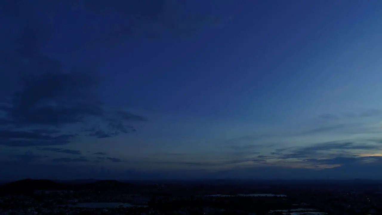 Aerial footage for Blue Hour during sunset revealing city lights and a highway