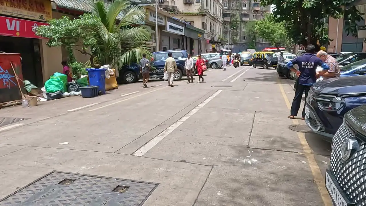 Mumbai India 20 August 2023 Street scene in Mumbai India with a motorbike passing with three passengers onboard