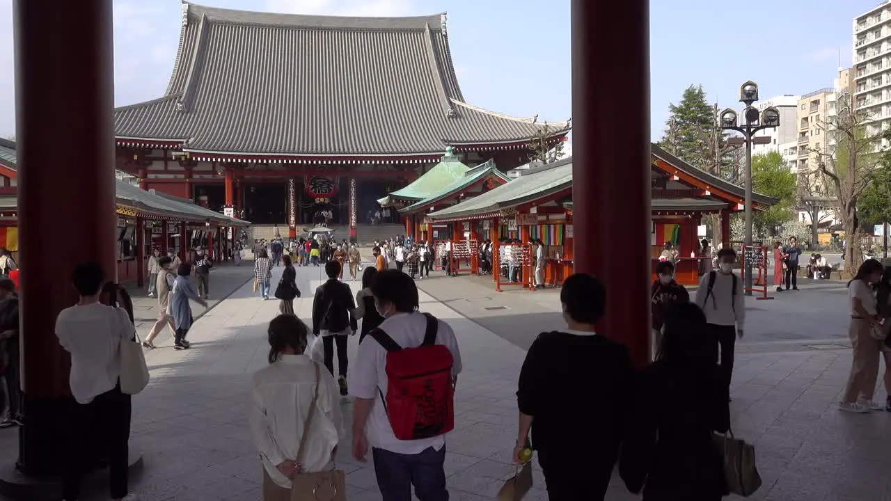 Cinematic approach towards Senso-ji Shrine in Tokyo with many tourists