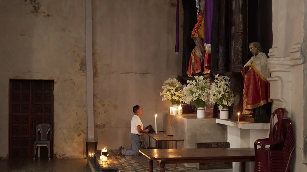 A man worships at an alter in the Santiago Atitlan church where Stanley Rother was murdered 1