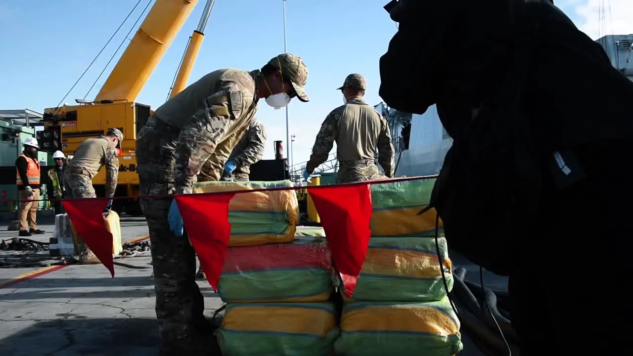 Us Coast Guardsmen And Canadian Navy Sailors Begin To Unload Seized Cocaine From A Canadian Ship