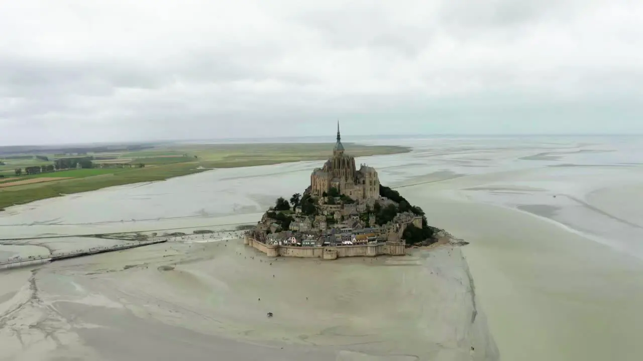 There is a castle in the middle of mont saint michel beach where there are many buildings castle in France