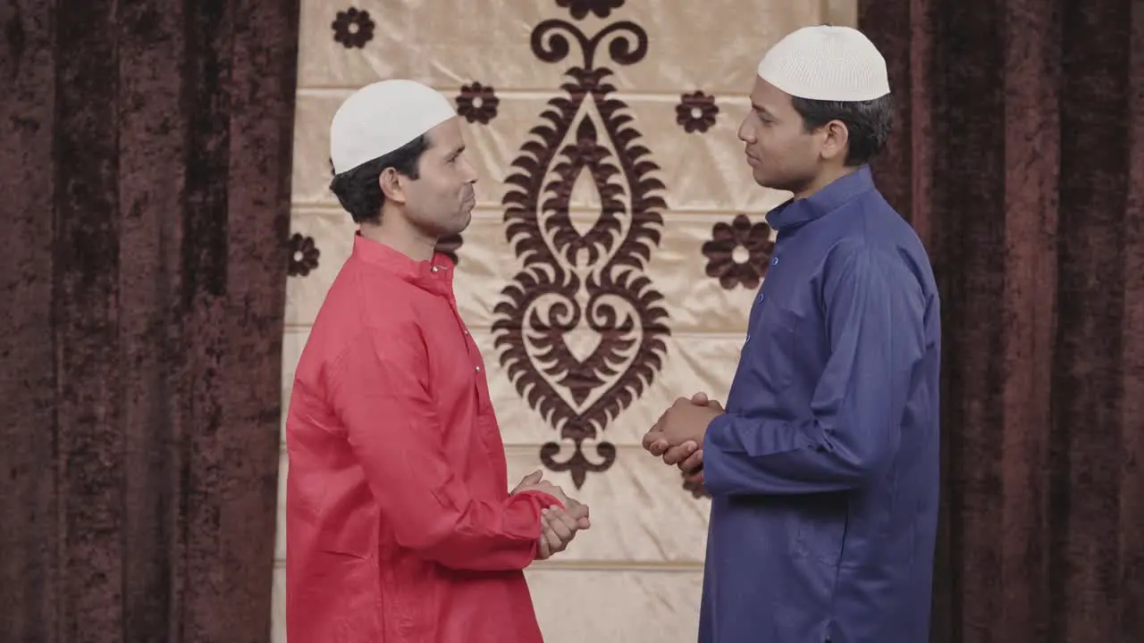 Two happy muslim men talking to each other