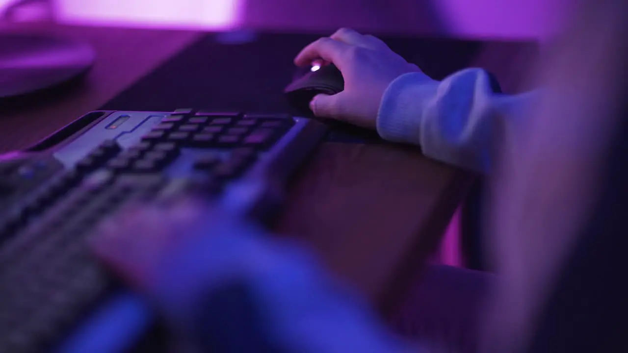 Close Up Hands Shot Showing a Gamer Pushing the Keyboard Buttons while Playing an Online Video Game