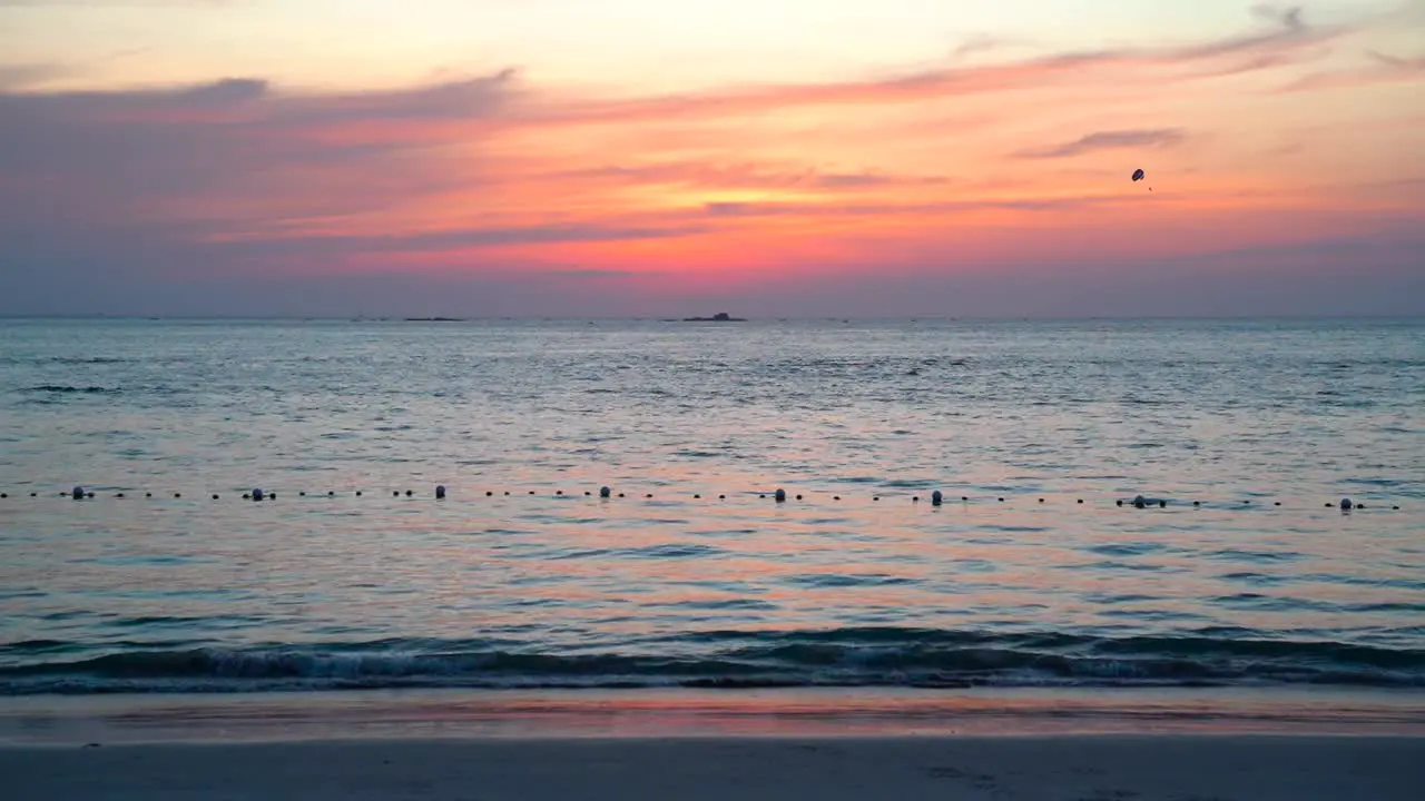 Small waves at the beach sea during beautiful red sunset