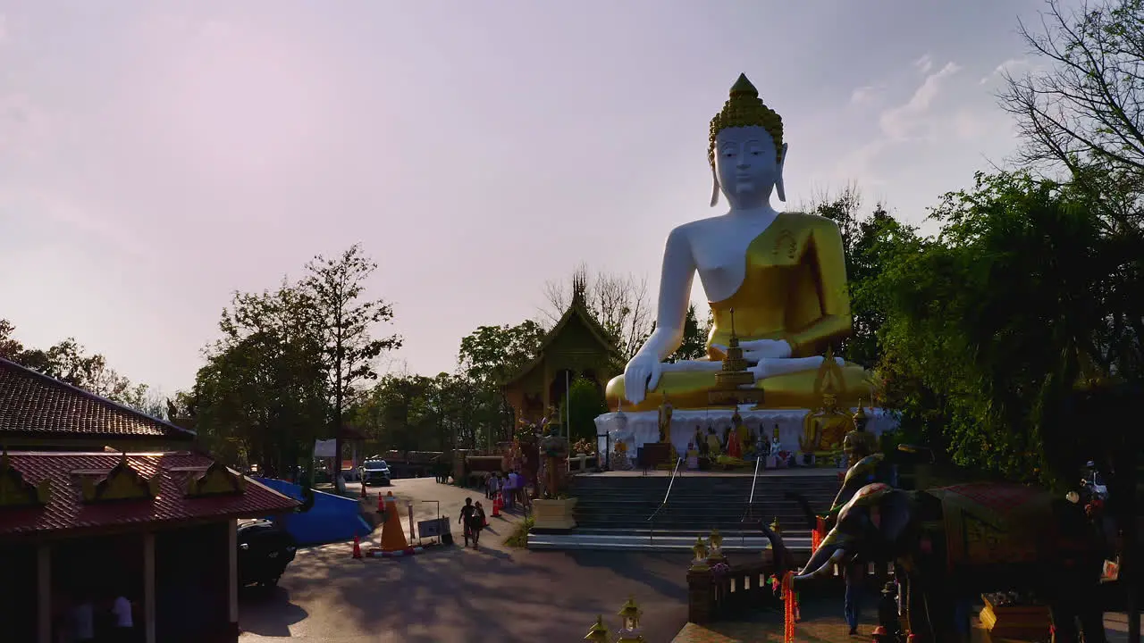 Wat Phra That Doi buddhist temple with golden Buddha statue at sunset