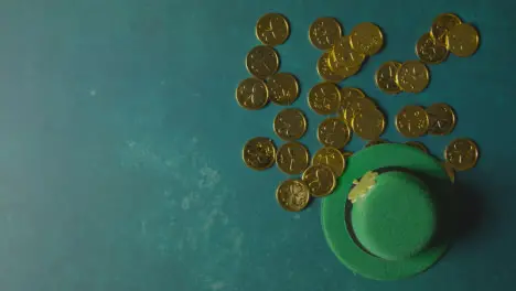 Overhead Studio Shot Of Green Leprechaun Top Hat And Piles Of Gold Coins To Celebrate St Patricks Day