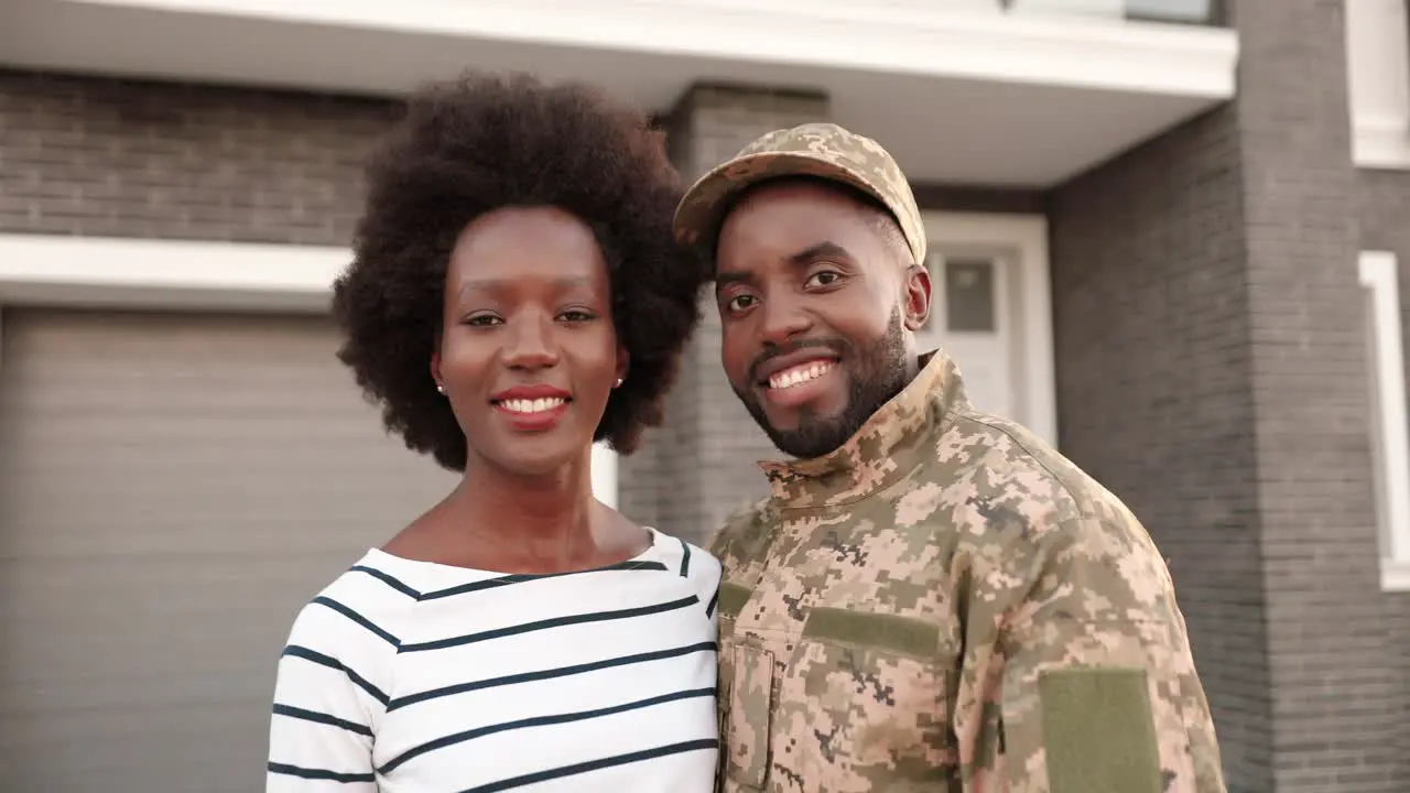 A Soldier And His Wife Are In The Porch Of Their Home