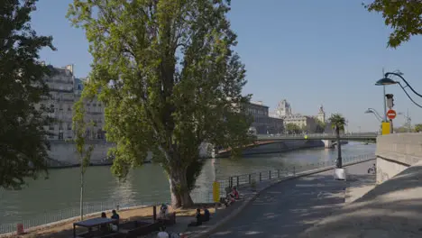 Quais De Seine In Paris France With People On Banks Of River