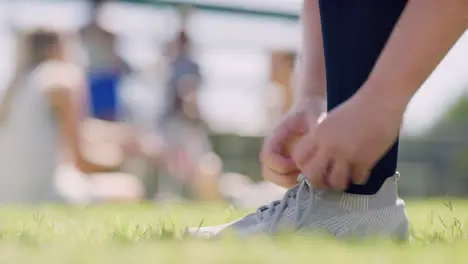 Closeup of a sportsperson tying shoelaces