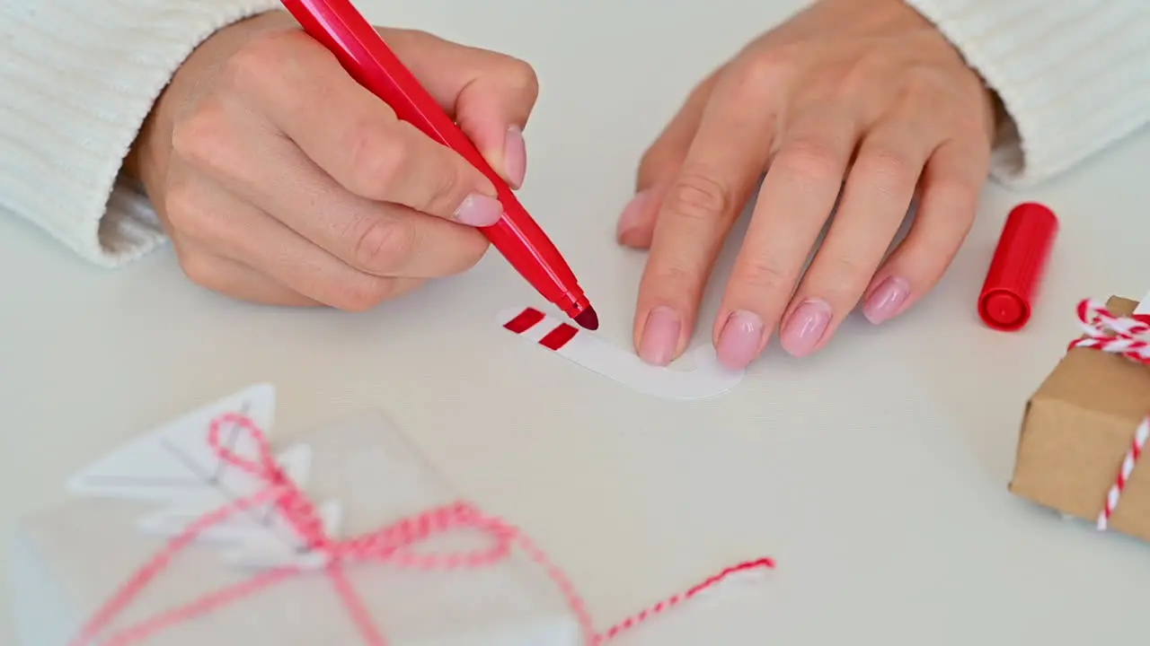 Female Hands Decorate And Color A Candy Cane Made Of Paper Using A Marker Pen