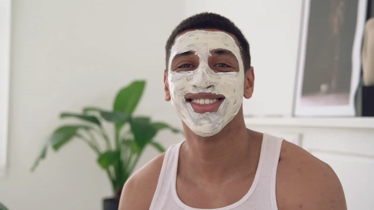 Portrait Of A Handsome Black Male With Facial Mask Looking At Camera And Smiling