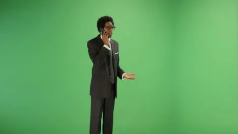 Annoyed Businessman talking on phone with green screen