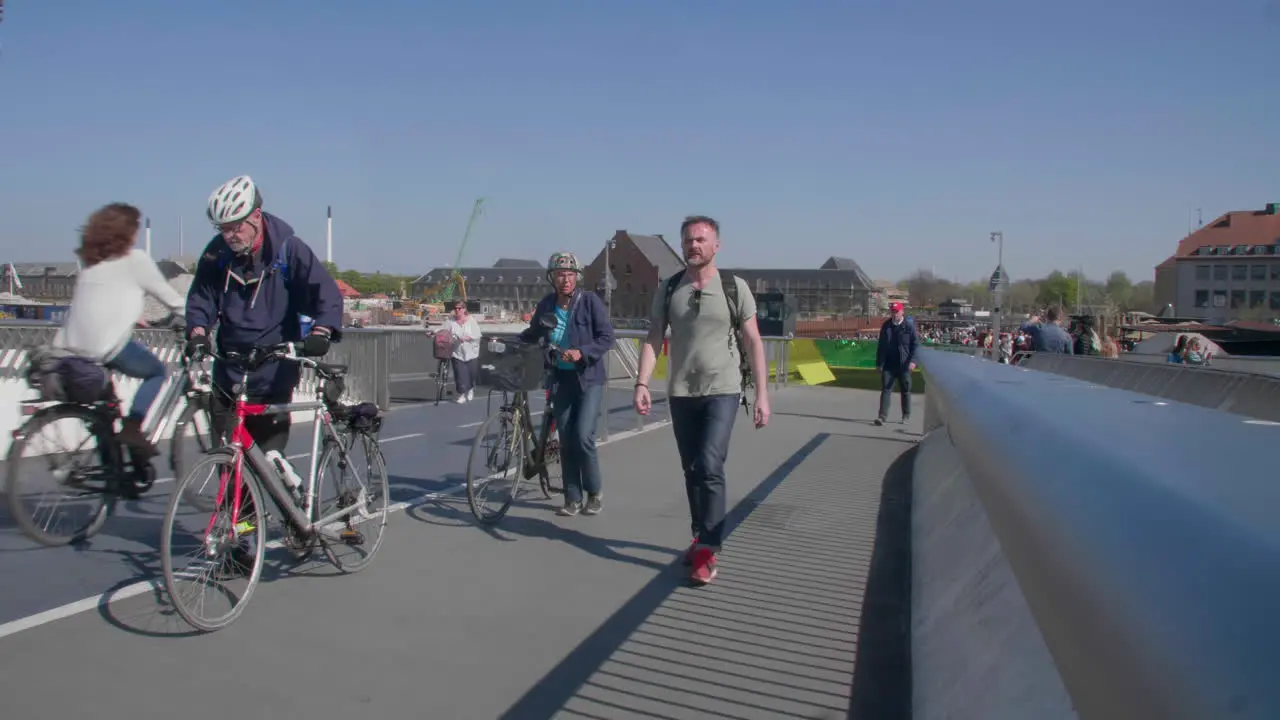 Cyclists and pedestrians enjoy a sunny day on Copenhagen's bicycle bridge