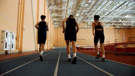 Back view of athletes running