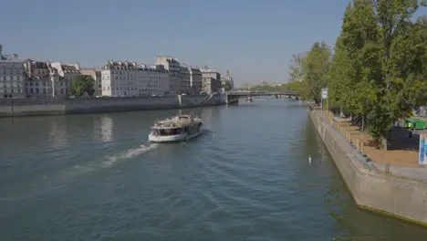 Tourist Boat Going Under Bridge In Quais De Seine Area Of Paris France 1